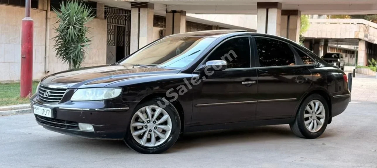 هيونداي ازيرا 2008 اتوماتيك 197,000 كم 6 سلندر دفع أمامي سيدان بني بنزين