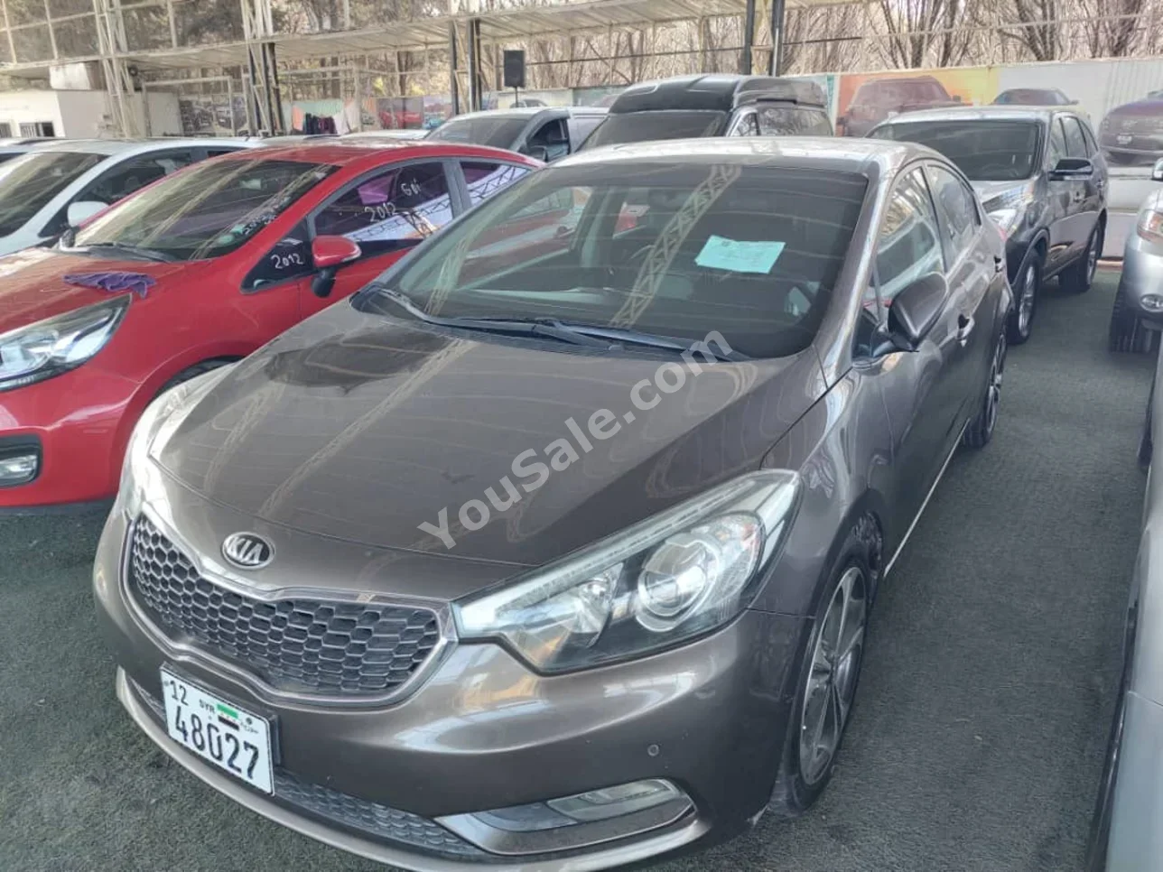 كيا سيراتو 2015 اتوماتيك 280,000 كم 4 سلندر دفع أمامي سيدان بني بنزين