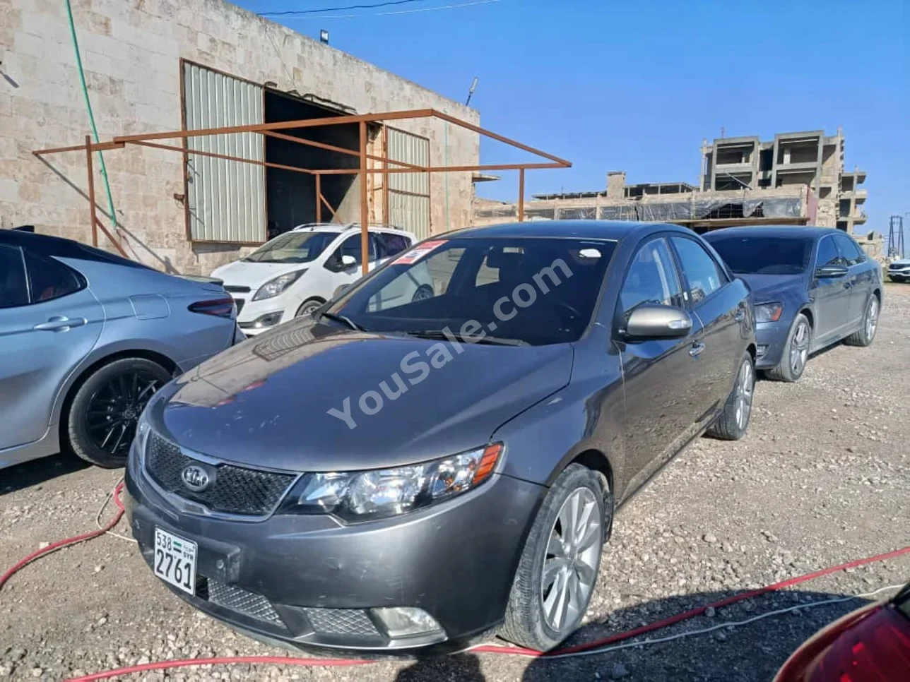 Kia  Forte  2010  Automatic  100,000 km  4 Cylinder  FWD  Sedan  Dark Gray  Gasoline